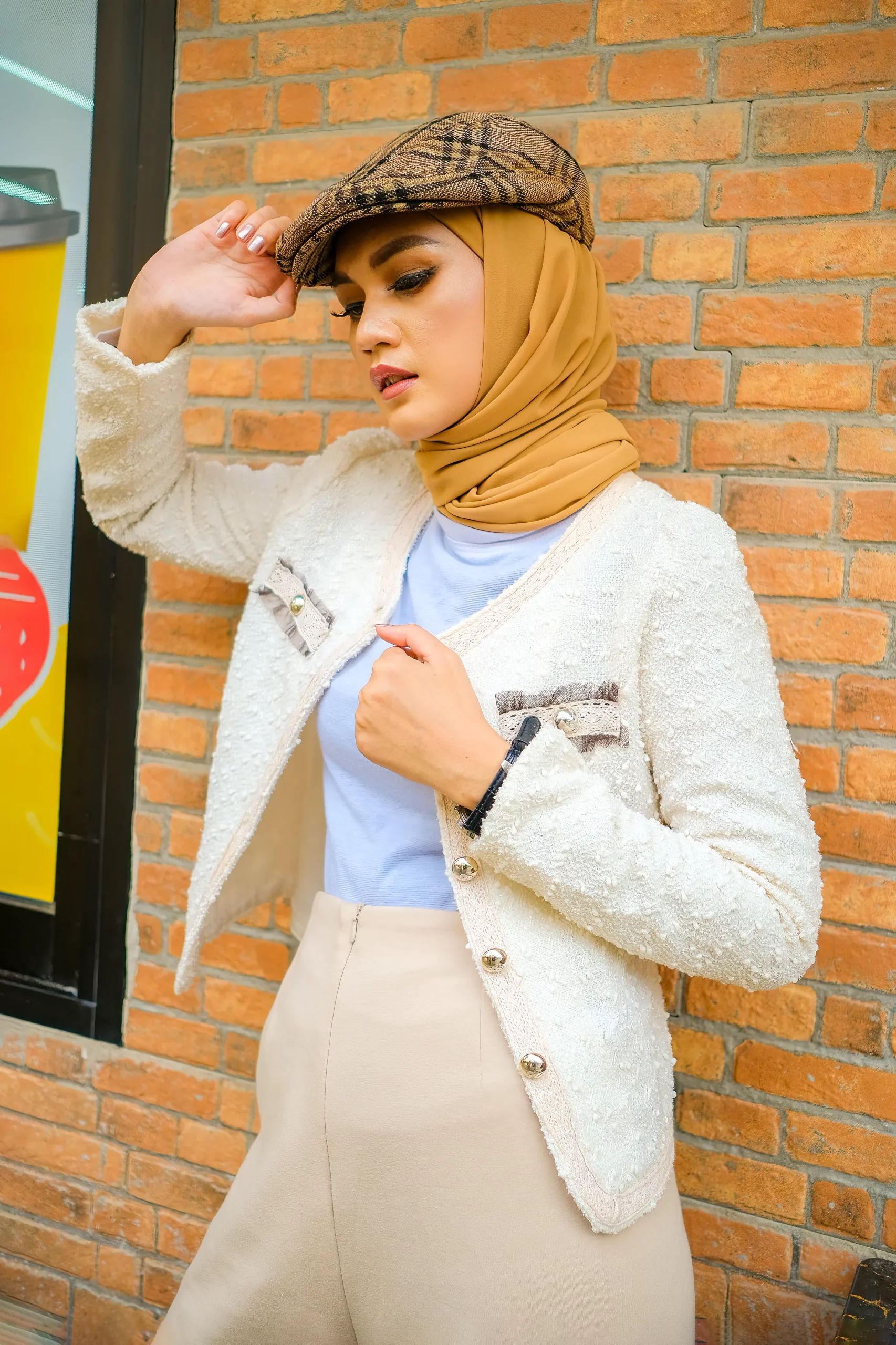 Close up image of hijab woman posing at brick wall wearing a beret