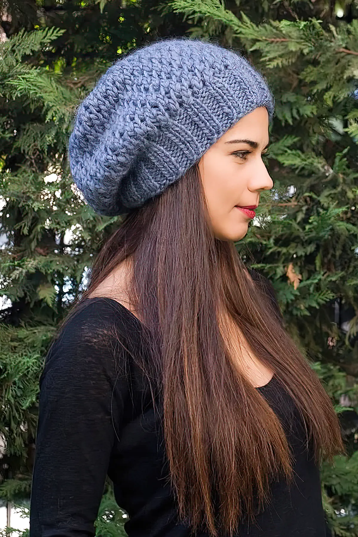 Woman with long hair wearing blue slouchy beanie
