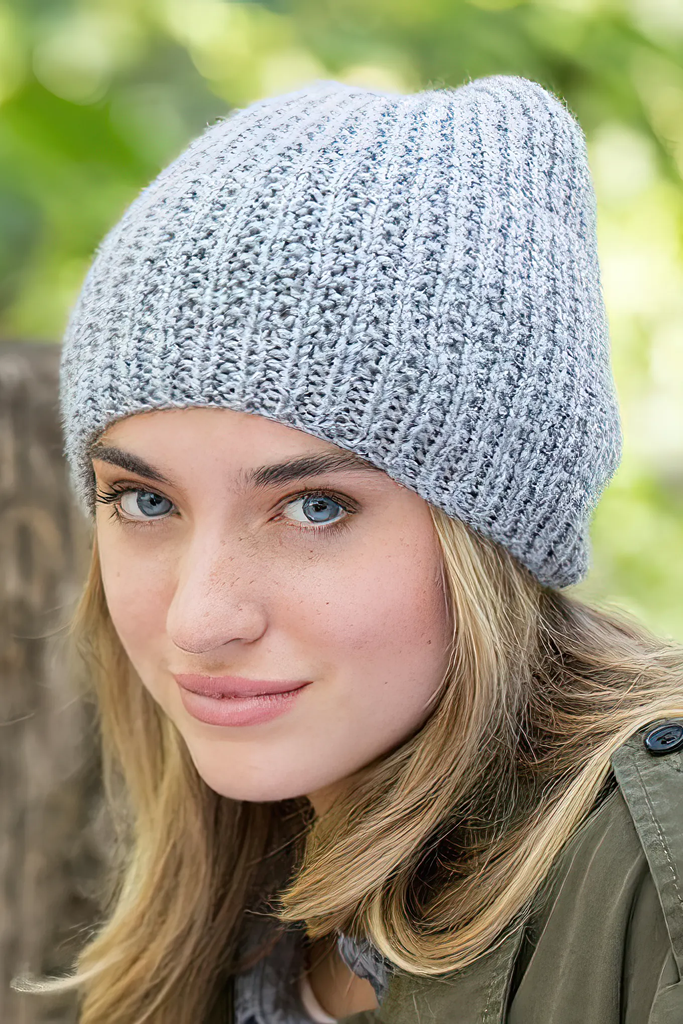 Woman with blonde hair wearing gray knit beanie