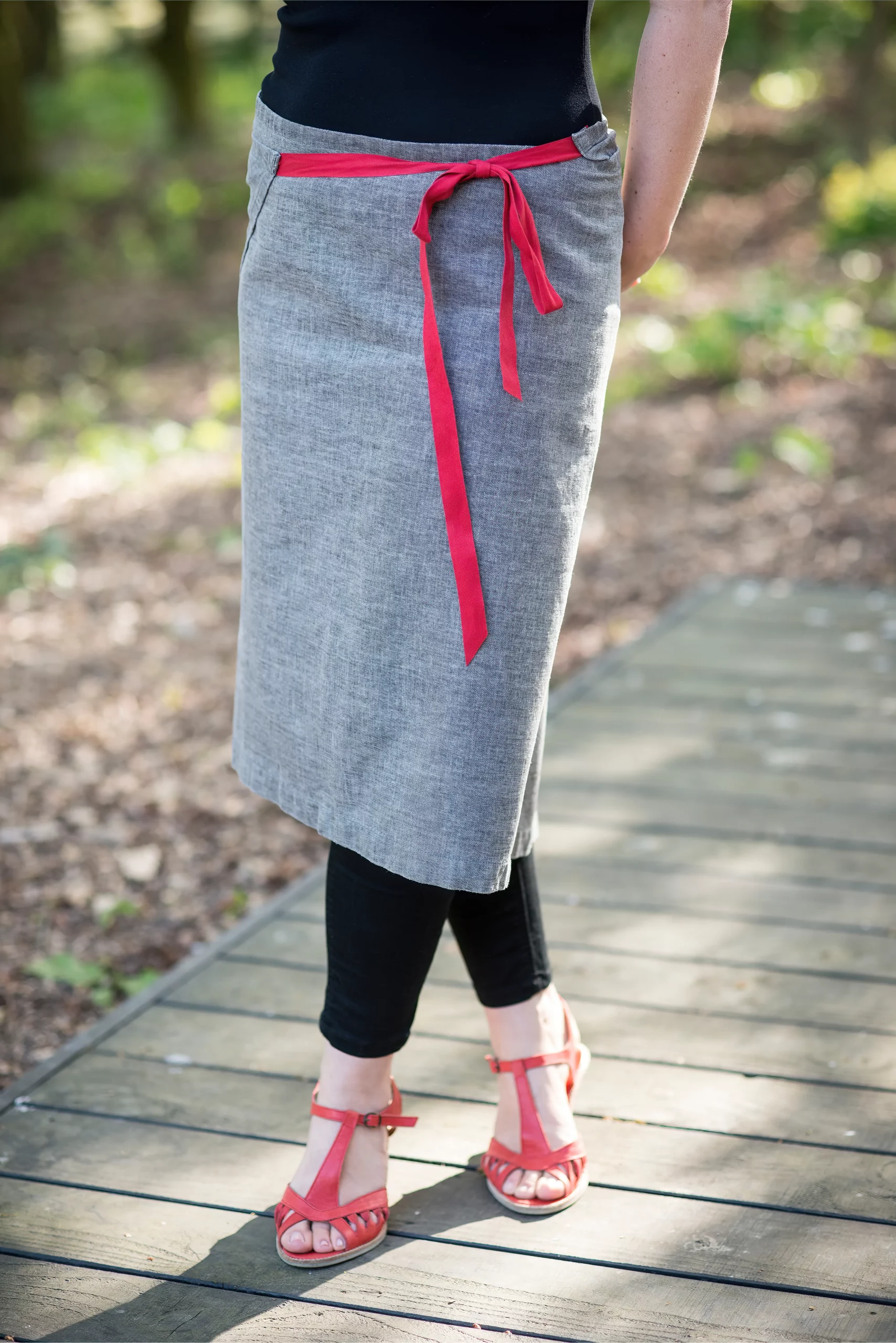 Crop image of gray pencil skirt with red cord belt