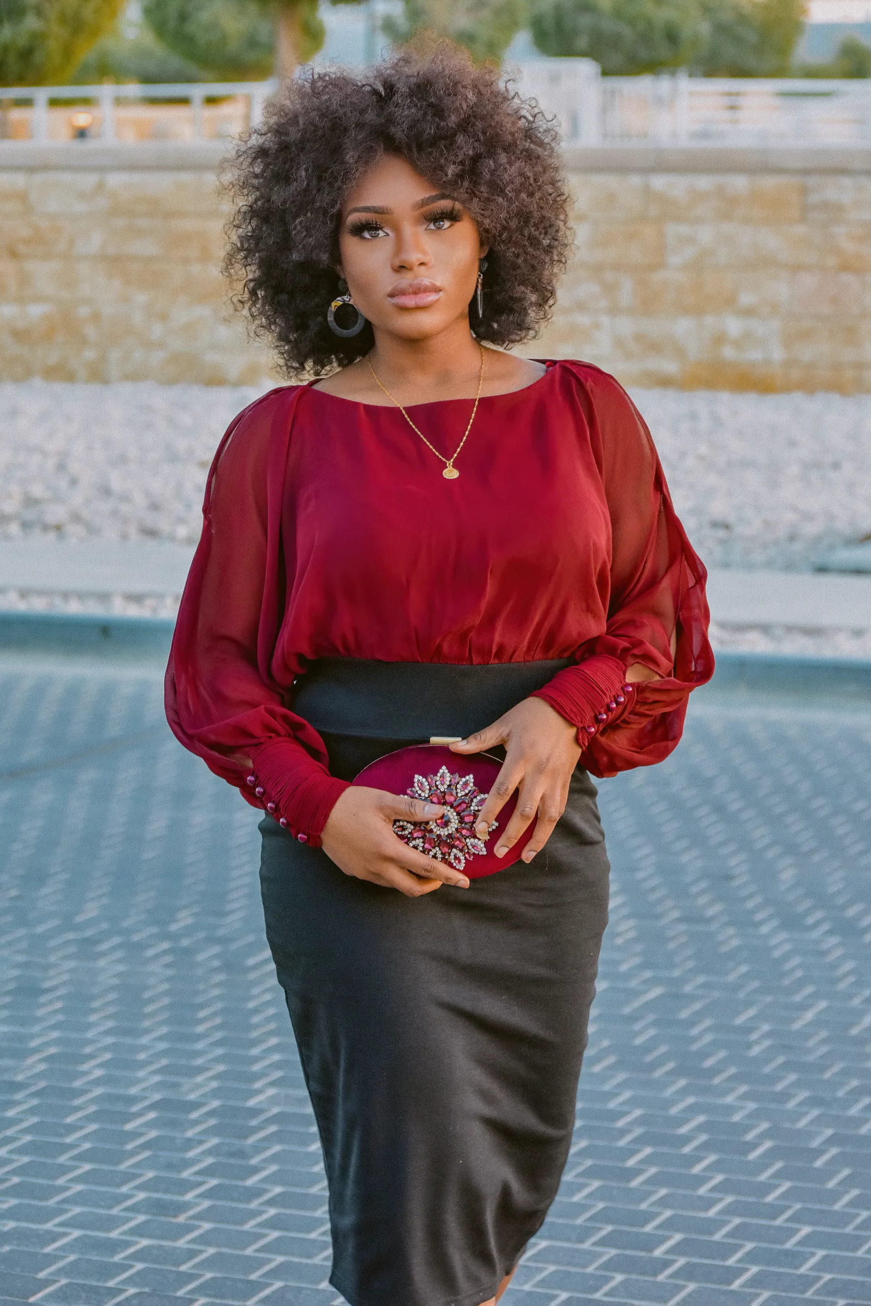 Fashionable black woman in red blouse and a black pencil skirt at street