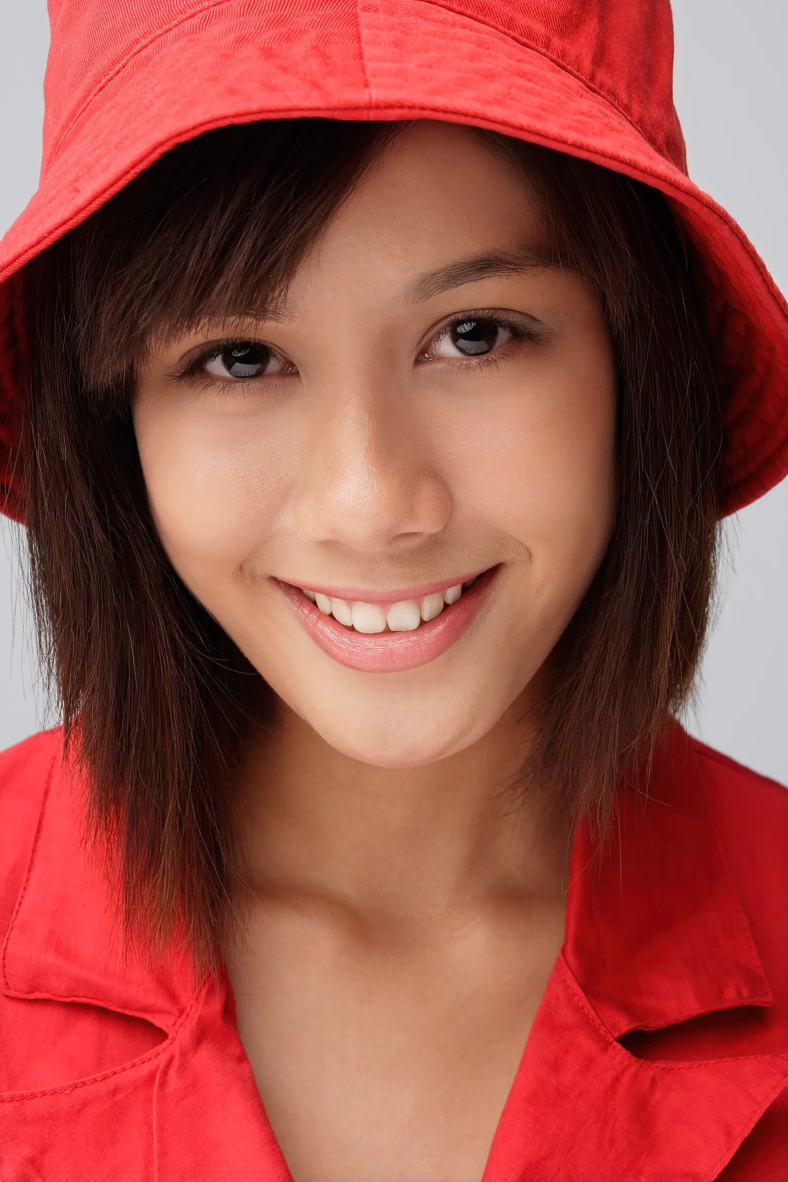 Close up image of young woman in red bucket hat
