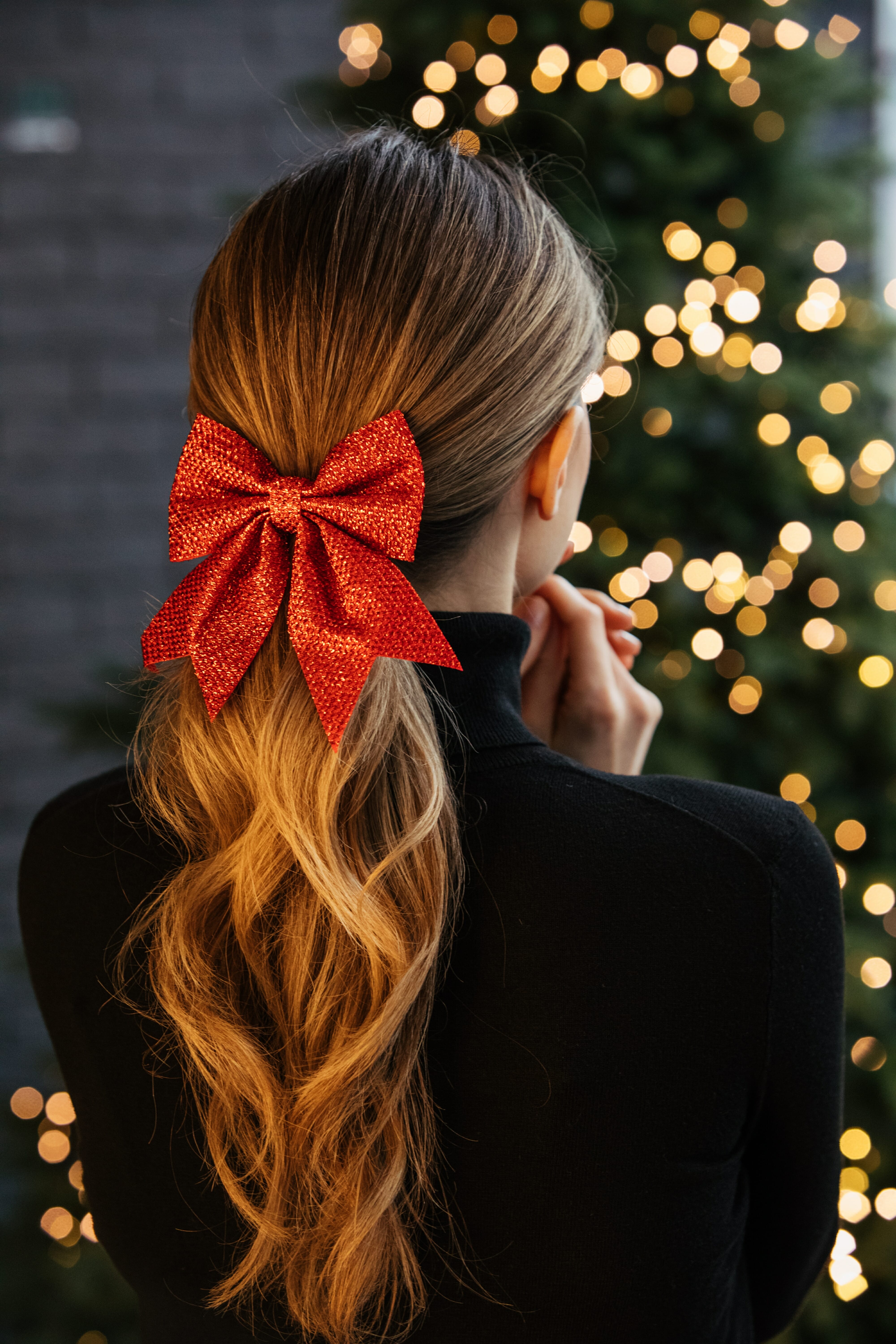 Girl with long blonde hair and red bow hair
